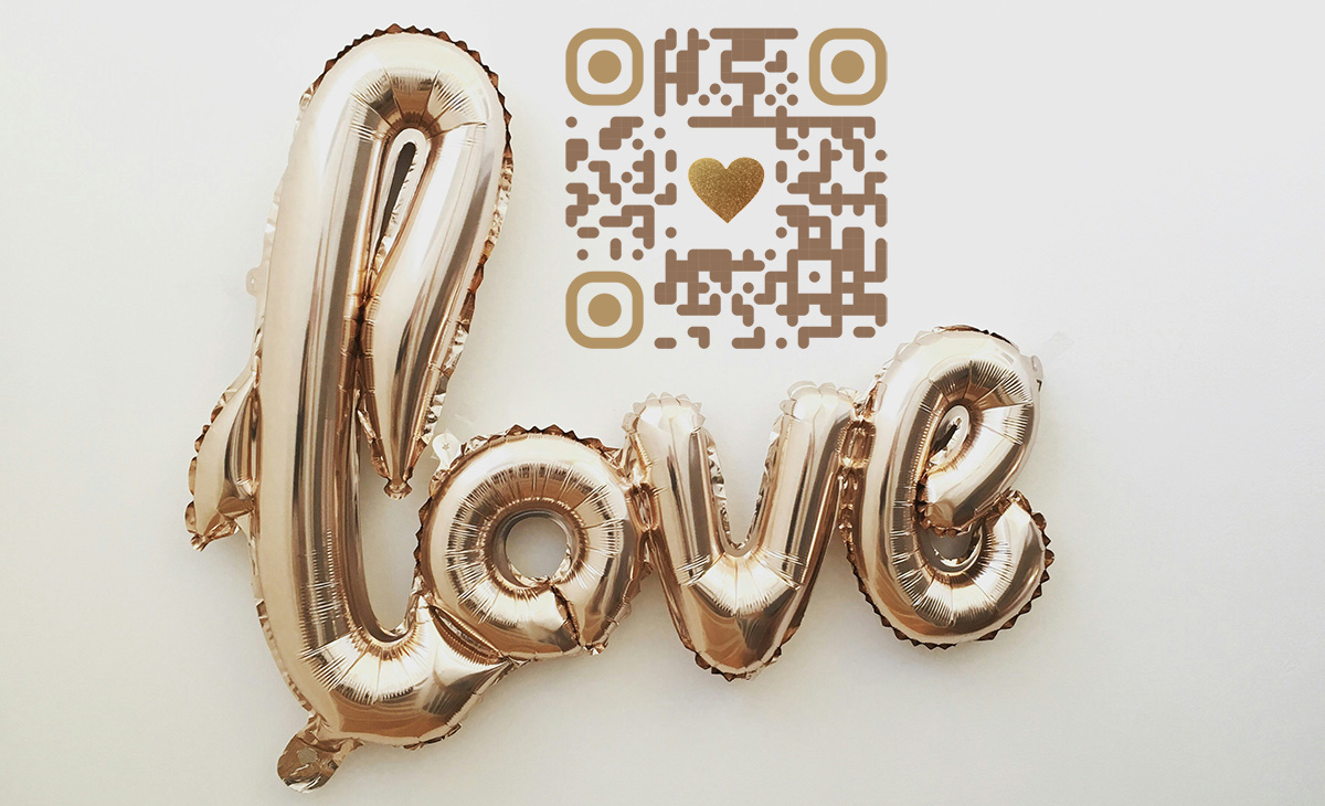 large golden balloon in the shape of the word "love" with a QR Code that links back to QR Hive website.