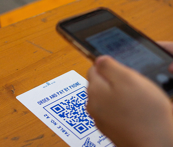 Sticker with a QR Code that allows the user to scan, order and pay online for fast service.